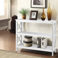 White console table with decorative items in a living room setting